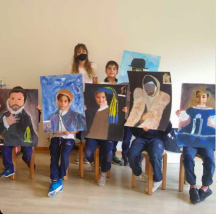 children and teacher with their paintings